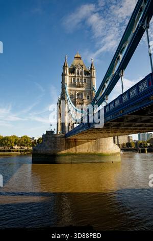 The iconic towers of Tower Bridge stride across the River Thames toward the Tower of London, England. Stock Photo