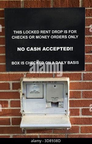 Locked Rent Drop Box Sign on Red Brick Wall Stock Photo