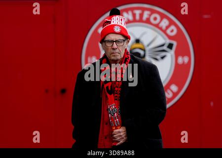 A Brentford fan outside the ground before the Premier League match at ...