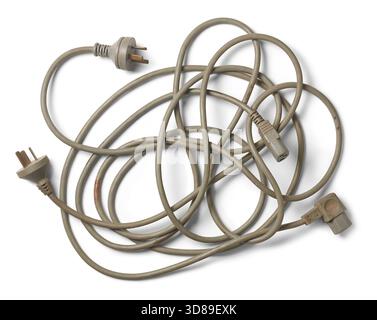 tangled heap of three-pronged electrical power cords, muted gray cables with plugs and connectors isolated white background Stock Photo