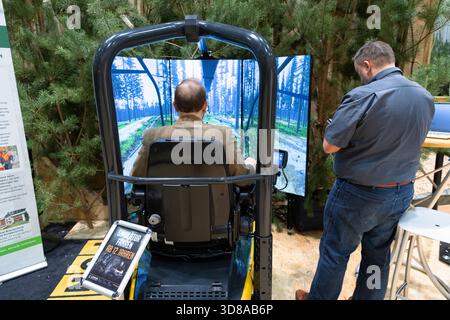 Berlin, Germany - January 22, 2024: Man is engaged with a virtual reality simulator showcasing a forest environment. Stock Photo