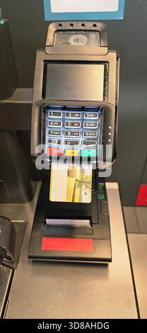 Berlin, Germany - September 27, 2025: Payment terminal features card reader and keypad for secure contactless transactions. Stock Photo