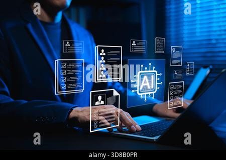 Businessman using AI-powered software on laptop for automated resume screening and candidate selection. Concept of artificial intelligence in HR tech, Stock Photo