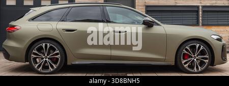 Slovenia, Ljubljana - 6 October 2025: Audi A5 stands sleekly in front of a contemporary home during daylight. Stock Photo