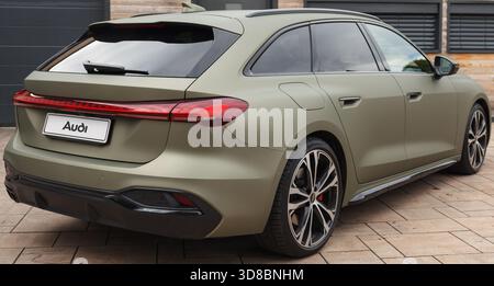 Slovenia, Ljubljana - 6 October 2025: Audi A5 parked on a paved driveway by a modern building. Stock Photo