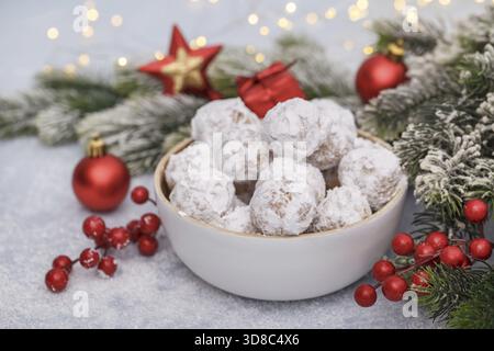 Traditional Christmas snowball cookies with almonds on snowy background Stock Photo