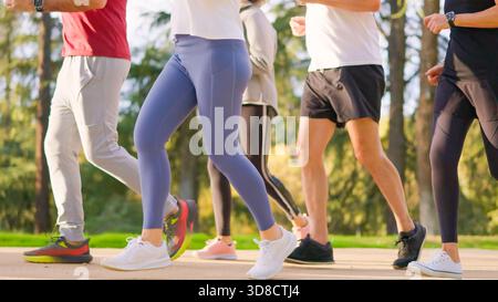 Senior athletic legs of senior friends jogging together in a park Stock Photo