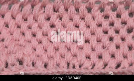 Knitting patterns for sweaters, hats, and other items using light-colored yarn on a light background. Copy space. Stock Photo