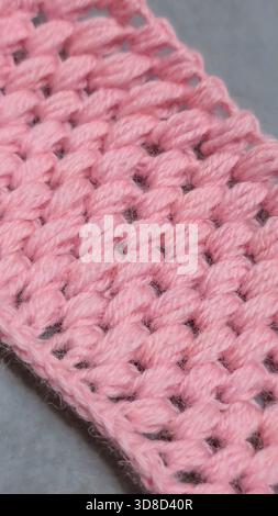 Knitting patterns for sweaters, hats, and other items using light-colored yarn on a light background. Copy space. Stock Photo