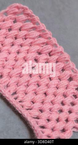 Knitting patterns for sweaters, hats, and other items using light-colored yarn on a light background. Copy space. Stock Photo