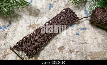 Knitting patterns for sweaters, hats, and other items using light-colored yarn on a light background. Copy space. Stock Photo