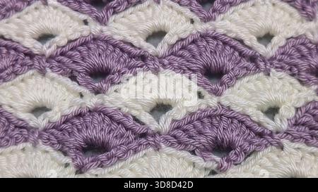 Knitting patterns for sweaters, hats, and other items using light-colored yarn on a light background. Copy space. Stock Photo