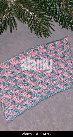Knitting patterns for sweaters, hats, and other items using light-colored yarn on a light background. Copy space. Stock Photo