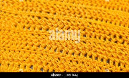 Knitting patterns for sweaters, hats, and other items using light-colored yarn on a light background. Copy space. Stock Photo