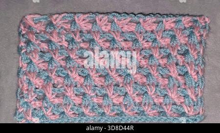 Knitting patterns for sweaters, hats, and other items using light-colored yarn on a light background. Copy space. Stock Photo