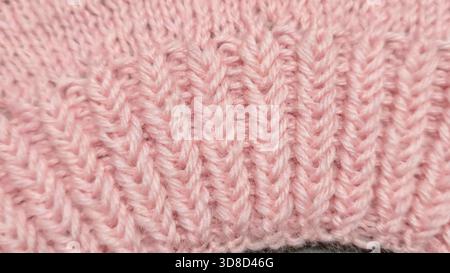 Knitting patterns for sweaters, hats, and other items using light-colored yarn on a light background. Copy space. Stock Photo