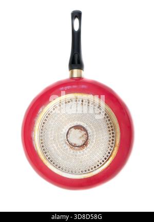 Bottom of a red frying pan on a white background. Stock Photo