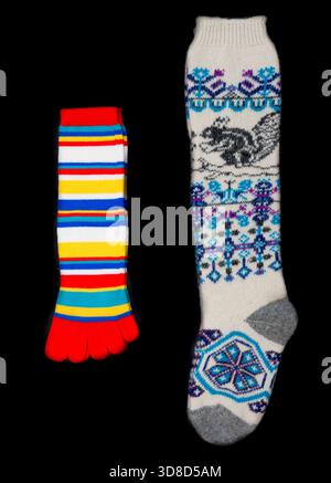 Multicolored socks on a black background. Stock Photo