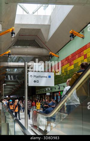 Melbourne, VIC, Australia. November 30, 2025. - Crowds of people navigate escalators and concourses inside Parkville Station, celebrating the Metro Tu Stock Photo
