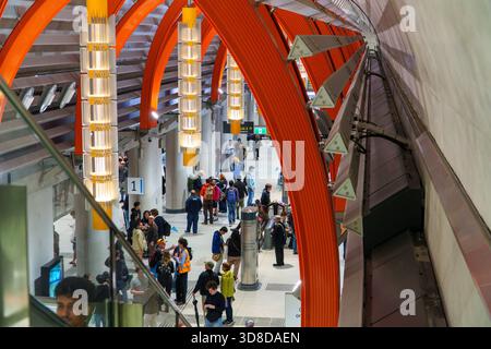 Melbourne, VIC, Australia. November 30, 2025. - Crowds of people explore the newly opened State Library Station, admiring its distinctive orange archi Stock Photo