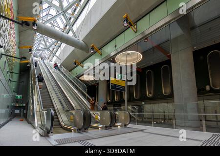 Melbourne, VIC, Australia. November 30, 2025. - Passengers use the new escalators in the bright, modern Parkville Station on Metro Tunnel Opening day, Stock Photo