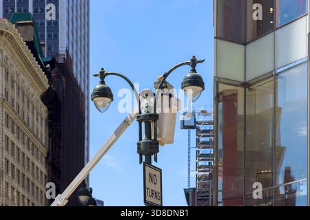 Workers are performing maintenance on streetlights in bustling city environment Stock Photo