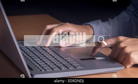 Technology Search Engine Optimization. man's hands are using a computer notebook to Searching for information. Stock Photo
