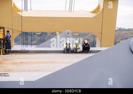 Engineers uses mobile phone wasting time on workplace, Industrial worker using mobile smartphone in industry Stock Photo