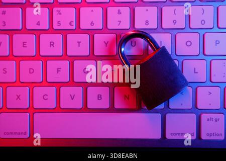 A padlock rests on a computer keyboard, symbolizing the critical need for cyber security in today's digital world. This scene highlights the importanc Stock Photo