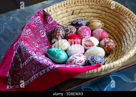 Wicker basket filled with colorful decorated eggs, representing Czech Easter traditions in Kourim Stock Photo