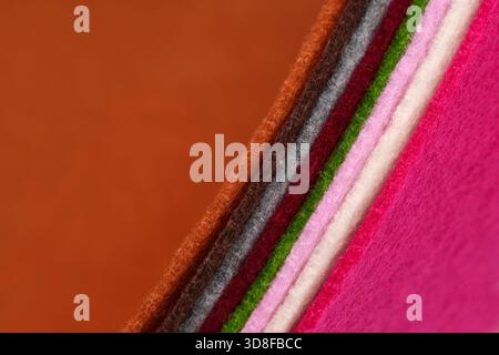 Colorful multicolored felt. The thickness is clearly visible. Samples of soft fabric. Wave. Close-up. For design projects, textile layouts, sewing. Stock Photo