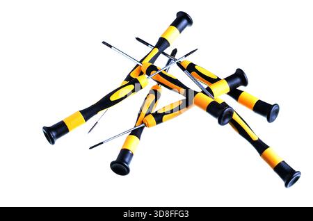 Close-up of a collection of yellow and black screwdrivers on a white background Stock Photo