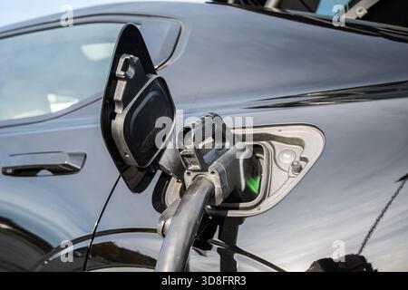 Oslo, Norway - October 14 2021: Type 2 CCS charging cable connected to an electric car.. Stock Photo
