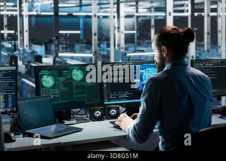 Data center engineer using AI assistant to manage global server infrastructure with international networks. Admin using artificial intelligence LLM to monitor worldwide system operations Stock Photo
