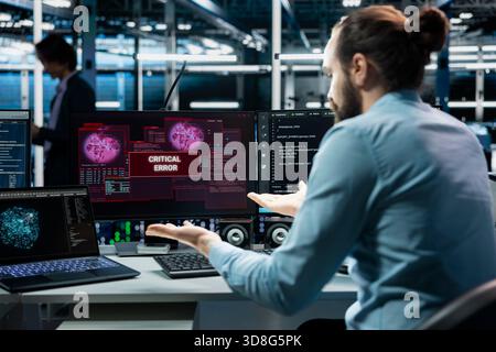 Data center computer scientist using AI LLM assistant to fix critical errors affecting hardware. Server farm IT employee using large language model chatbot to eliminate glitches Stock Photo
