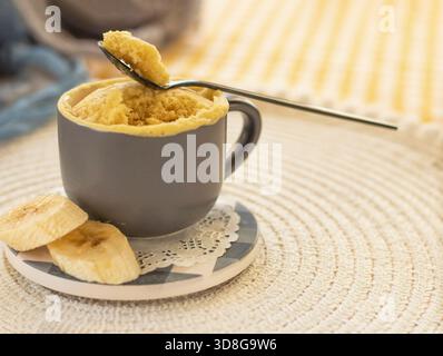 mini cake. Breakfast in a mug. homemade Portioned Banana mugcake in small mugs. Stock Photo