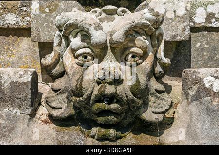 Italy - Caprarola - Palazzo Farnese - Close up of a grotesque stone mask fountain in the gardens Stock Photo