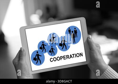 Cooperation concept shown on a tablet held by a woman Stock Photo