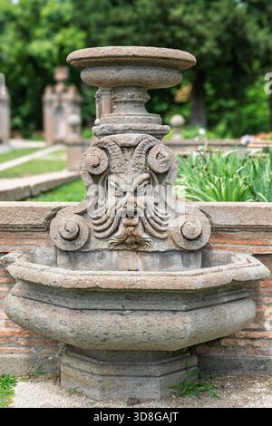 Italy - Caprarola - Palazzo Farnese - Grotesque stone mask fountain in the formal Renaissance gardens Stock Photo