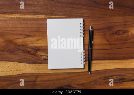 blank notebook and pen on wooden table Stock Photo