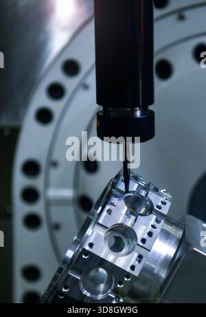 Spindle cutting tool Rotary 5-axis CNC milling machine during deburring of engine parts, heavy industry plan Stock Photo