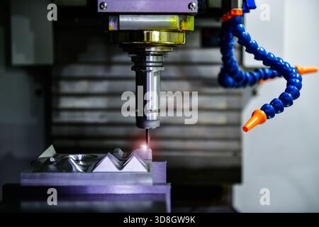 Spindle cutting tool Rotary 5-axis CNC milling machine during deburring of engine parts, heavy industry plan Stock Photo