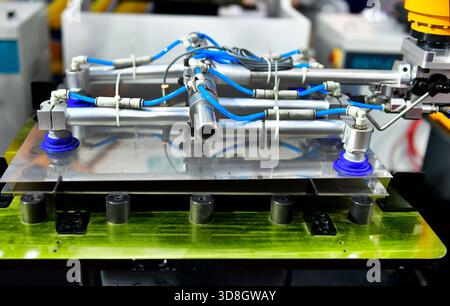 Robot arm control the Steel sheet cutting process in the industrial factory Stock Photo