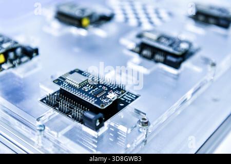 Macro Shot of Computer Processor Production Line print circuit board (PCB) in Bright Environment in Factory. Stock Photo