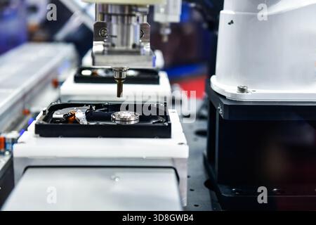 Automatic machinery for assembling and inspecting hard disk drives in the production line Stock Photo