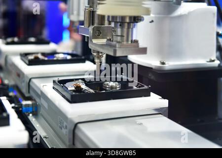 Automatic machinery for assembling and inspecting hard disk drives in the production line Stock Photo