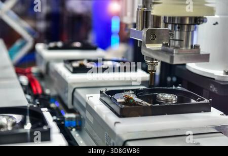 Automatic machinery for assembling and inspecting hard disk drives in the production line Stock Photo