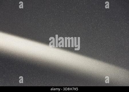 Calm abstract background showing diagonal ray of light on dark grey texture. This minimal, simple, modern pattern with shadow effect creates serene mo Stock Photo