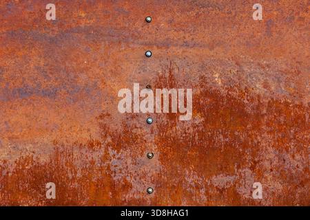 Rusty metal row of hexagonal screws or bolt heads Stock Photo