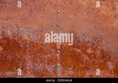 Rusty metal row of hexagonal screws or bolt heads Stock Photo